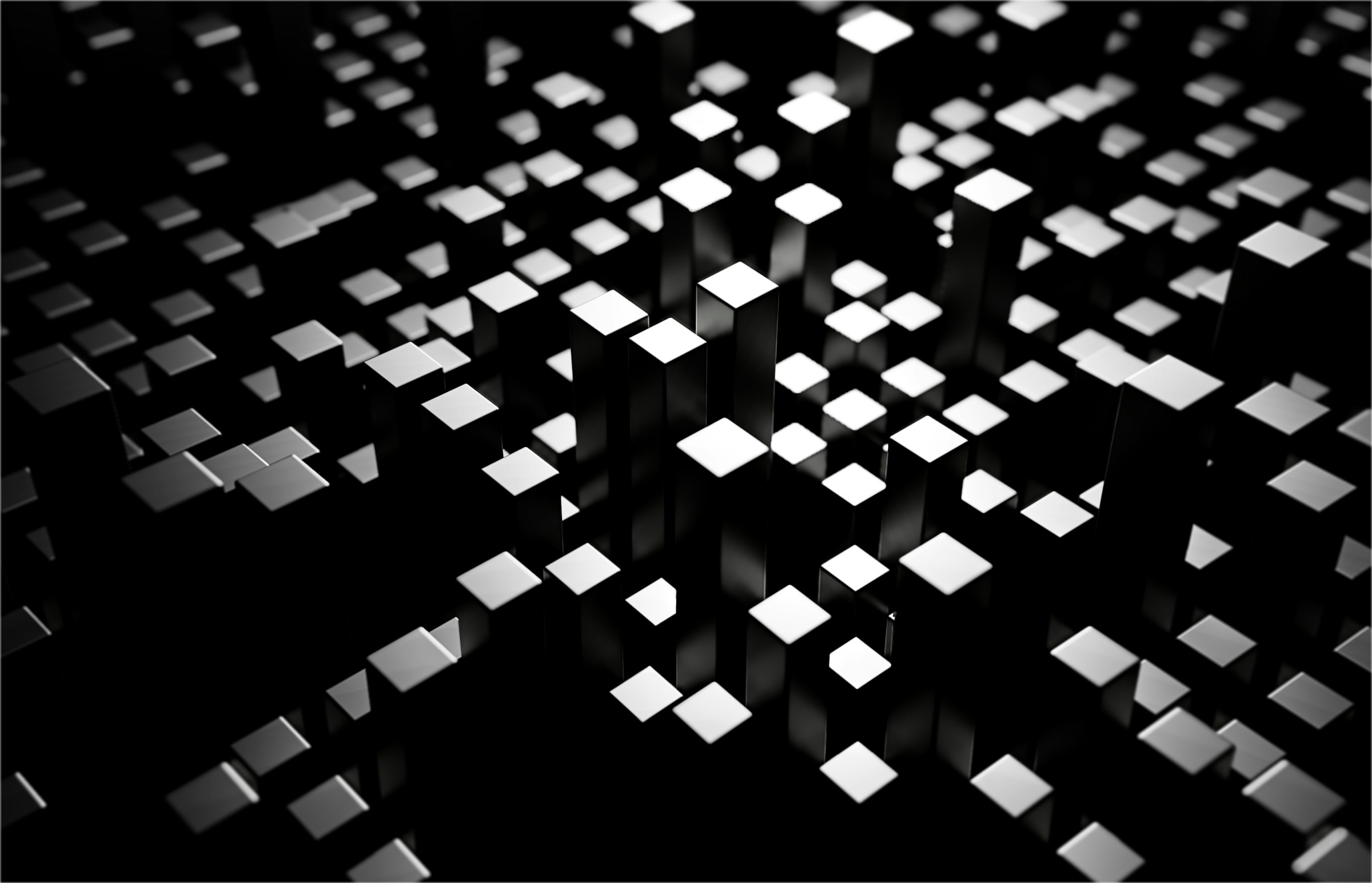 Reflective silver cubes arranged as an abstract geometric field.